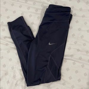 Purple nike leggings, dri fit, mesh on sides.